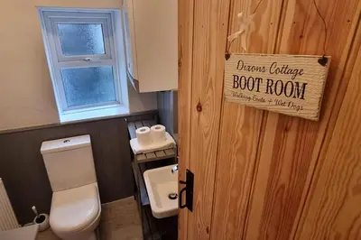 a bathroom with a toilet and a door with a sign at Luxury Lake District Retreat above Ennerdale in Kirkland