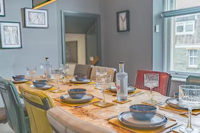 a long table with plates and glasses and a bottle at The Eyrie in Keswick