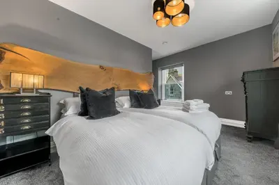 a bedroom with two beds and a window at The Eyrie in Keswick