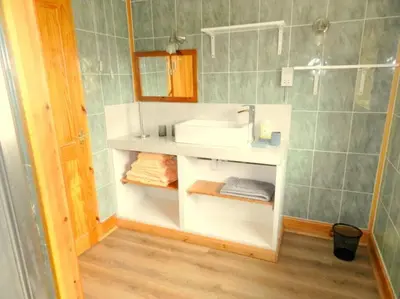 a bathroom with a white sink and a mirror at Annexe Meadowbank Dumfries in Dumfries