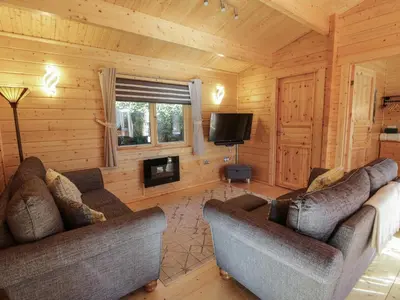 a living room with two couches and a television at Little Lodge in Newton Stewart