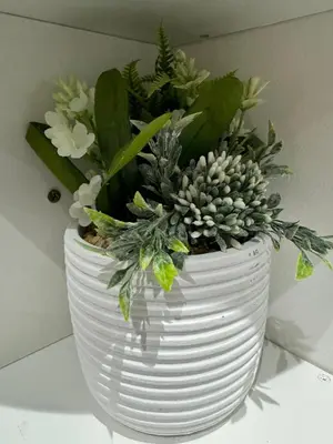 a white vase filled with plants on a table at Quayside Apartment -2 Bedrooms - Sleeps 4 in Whitehaven