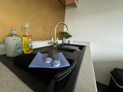 a kitchen counter with a sink with a tray of food at Quayside Apartment -2 Bedrooms - Sleeps 4 in Whitehaven