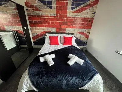 a bedroom with a bed with crosses on it at Quayside Apartment -2 Bedrooms - Sleeps 4 in Whitehaven