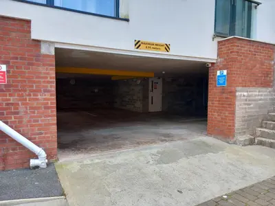 an empty parking garage with a brick building at Quayside Apartment -2 Bedrooms - Sleeps 4 in Whitehaven