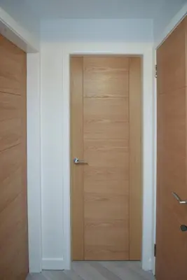 a corridor with two wooden doors in a room at Dumfries Apartment 2 in Dumfries