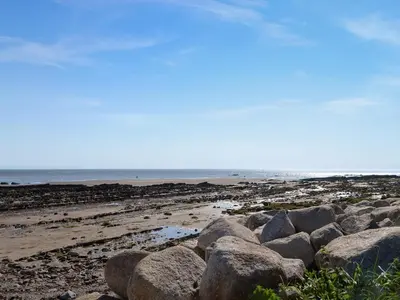 a group of rocks on a beach with the ocean at Sea View 59 - Uk45586 in Mainsriddle