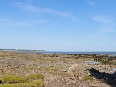 a rocky beach with the ocean in the background at Sea View 59 - Uk45586 in Mainsriddle