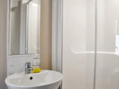 a bathroom with a white sink and a shower at Sea View 59 - Uk45586 in Mainsriddle