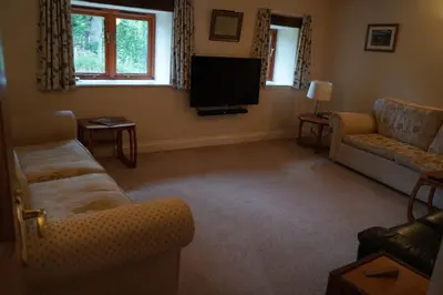 a living room with two couches and a flat screen tv at North Lake District rural retreat in Penrith