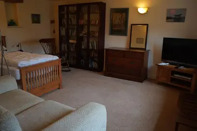 a living room with a couch and a television at North Lake District rural retreat in Penrith