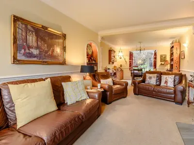 a living room with leather couches and chairs at 3 Bed in Portinscale 93949 in Portinscale