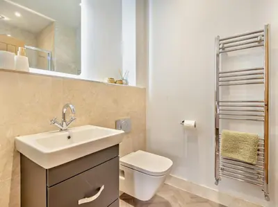 a bathroom with a sink and a toilet and a mirror at 3 Bed in Loweswater 94152 in Arlecdon