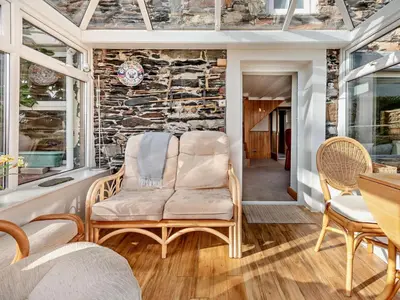 a room with a chair and a stone wall at 3 Bed in Keswick oc-94346 in Threlkeld