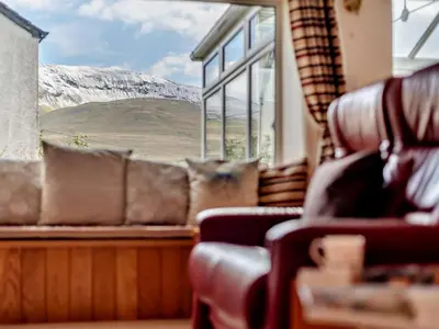 a living room with a couch and a large window at 3 Bed in Keswick oc-94346 in Threlkeld