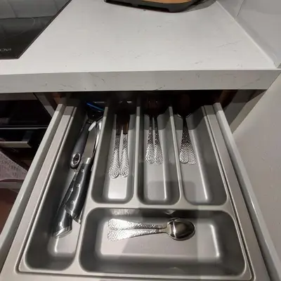a kitchen sink with utensils in a drawer at Kirkcudbright Holiday Apartments - Apartment A in Kirkcudbright