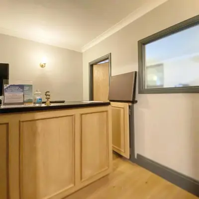 a kitchen with a counter and a refrigerator and a window at Kings Arms Hotel in Lockerbie