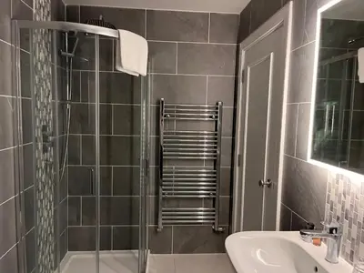 a bathroom with a shower and a sink at Kings Arms Hotel in Lockerbie