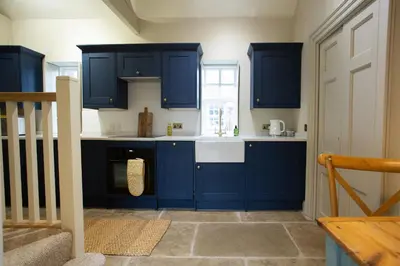 a kitchen with blue cabinets and a sink at The Tower in Carlisle