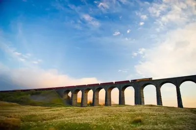 a train is crossing a bridge on a train at *Luxury Apartment 2min from City in Carlisle
