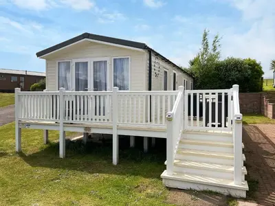 a white house with a porch and stairs at Sandy Paws - Uk45511 in Mainsriddle