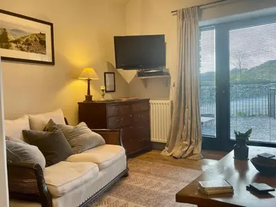 a living room with a couch and a tv at 1 Bed in Ullswater 94064 in Watermillock