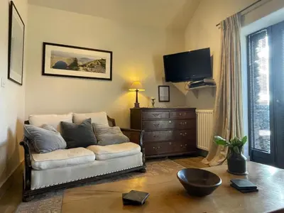 a living room with a couch and a flat screen tv at 1 Bed in Ullswater 94064 in Watermillock