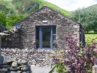 a small stone house with a stone wall at 1 Bed in Watermillock 94068 in Watermillock