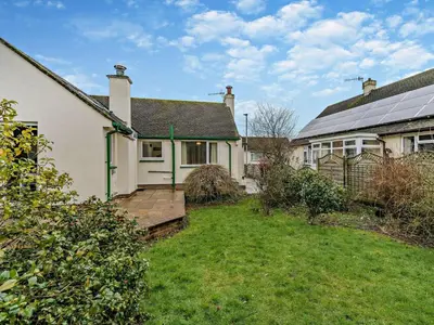 a house with a wooden deck in front of a yard at 1 Bed in Keswick oc-94245 in Keswick