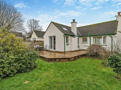 a white house with a deck in the yard at 1 Bed in Keswick oc-94245 in Keswick