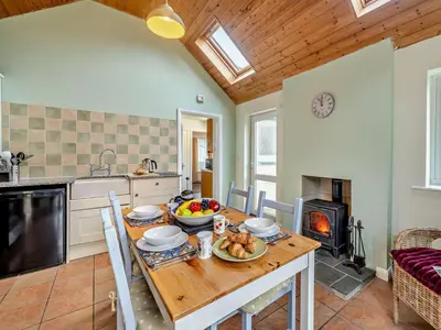 a kitchen and dining room with a table with food on it at 1 Bed in Keswick oc-94245 in Keswick