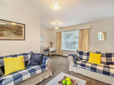 a living room with two couches and a table at 1 Bed in Keswick oc-94245 in Keswick