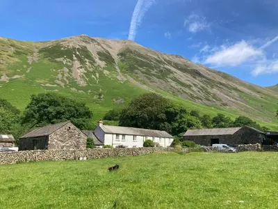 a group of buildings in front of a mountain at Burnthwaite Farm B&B in Wasdale
