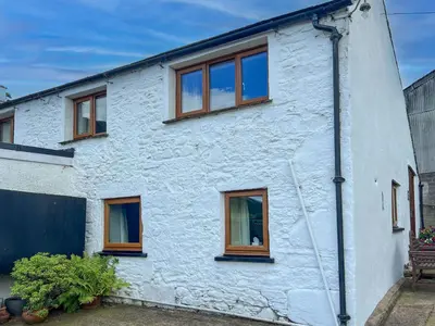 a white house with brown windows on it at Fell View Bassenthwaite, rural location on a working farm in the fells in Bassenthwaite