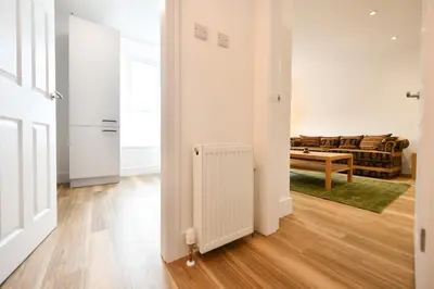 an open hallway with a living room and a radiator at Troon Portland Apt A in Troon