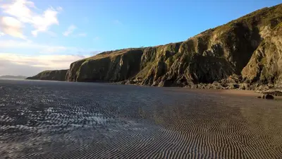 a view of a beach with a cliff at The Well in Mainsriddle