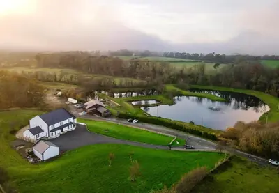 an aerial view of a house and a lake at Coylebrae House in Ayr