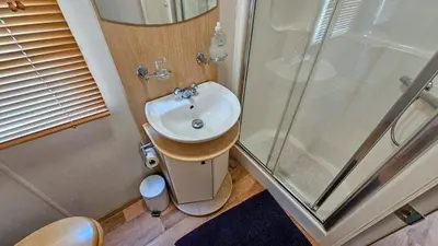 a bathroom with a sink and a shower at Foxgloves and Ivy in Cockermouth