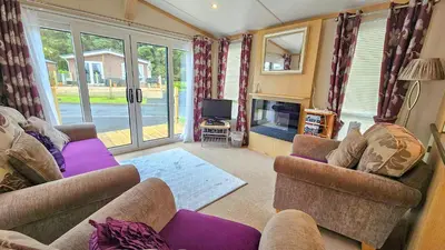 a living room with two couches and a tv at Foxgloves and Ivy in Cockermouth