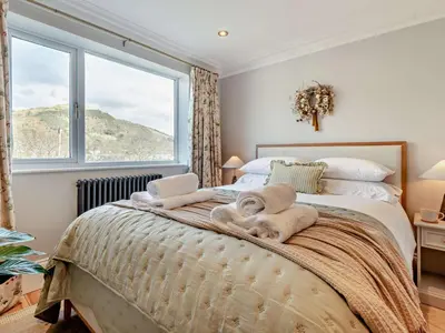 a bedroom with a large bed with a window at 6 Bed in Keswick 94361 in Keswick