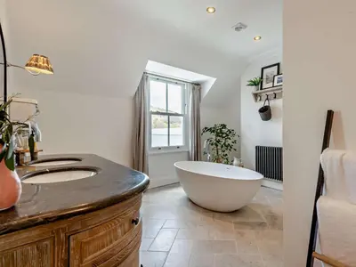 a bathroom with a large tub and a sink at 6 Bed in Keswick 94361 in Keswick