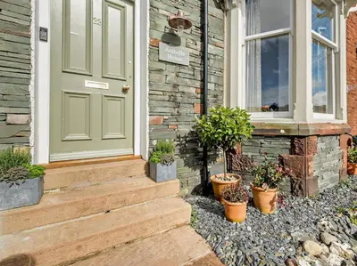 a house with a green door and potted plants at 6 Bed in Keswick 94361 in Keswick