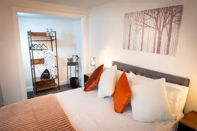 a bedroom with a bed with orange and white pillows at Kings Arms Suites - Luxury Double - Waterfall Shower - Self Check In in Whitehaven