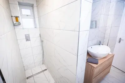 a white bathroom with a sink and a shower at Kings Arms Suites - Luxury Double - Waterfall Shower - Self Check In in Whitehaven