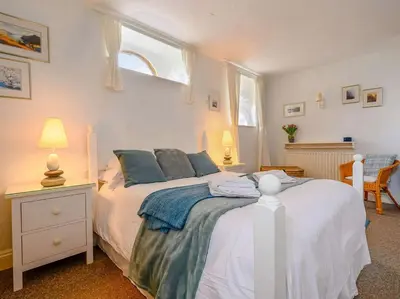 a bedroom with a bed and a window at 3 Bed in Watermillock SZ318 in Watermillock