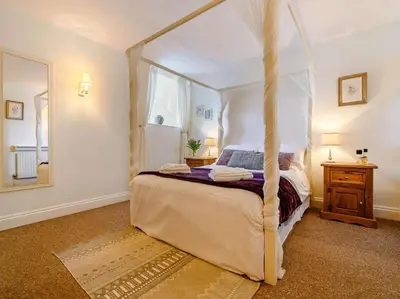 a bedroom with a canopy bed in a room at 3 Bed in Watermillock SZ318 in Watermillock