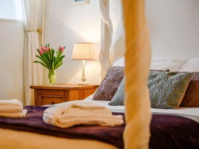 a bedroom with a bed and a table with a lamp at 3 Bed in Watermillock SZ318 in Watermillock