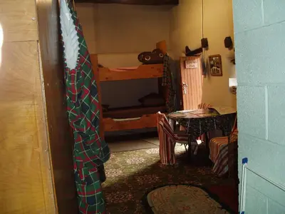 a room with a table and a bunk bed at Fisher-gill Camping Barn in Thirlmere