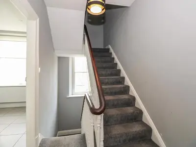 a staircase in a home with a light fixture at Baystones in Keswick