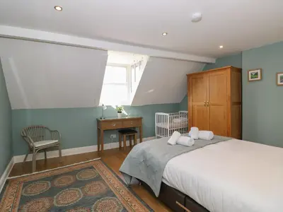 a bedroom with a bed and a window at Baystones in Keswick